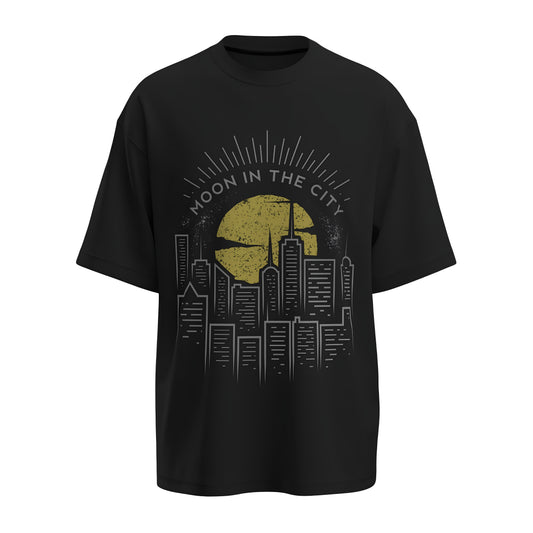 Front view of the premium oversized black t-shirt titled “Moon In The City” from Kashiba U with cool graphic design inspired by street art printed at the front of the t-shirt. Shop trendy streetwear graphic tee from the website of Kashiba U online. Buy Now!