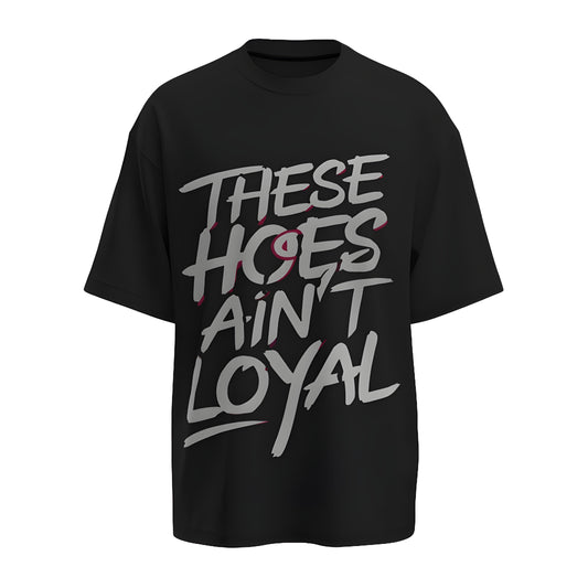 Front view of the premium oversized black t-shirt titled “These hoes ain't loyal” from Kashiba U with cool graphic design inspired by street art printed at the front of the t-shirt. Shop trendy streetwear graphic tee from the website of Kashiba U online. Buy Now!